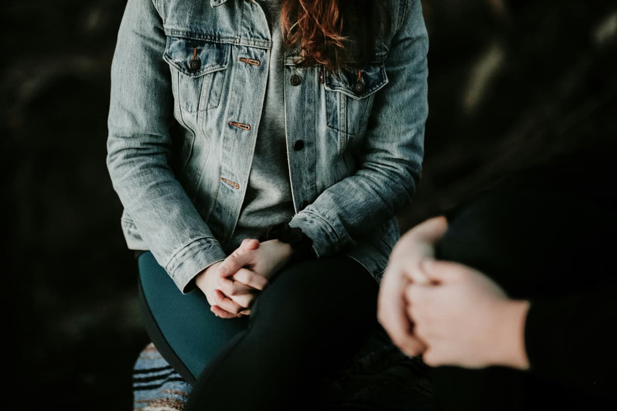 A mental health assessment conversation with notes and clinical materials.